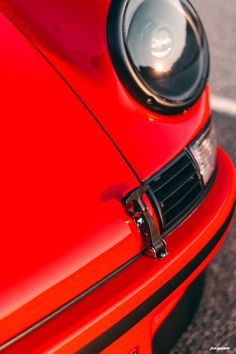 the front end of a red sports car