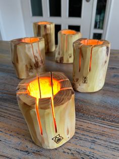 four wooden candle holders sitting on top of a table