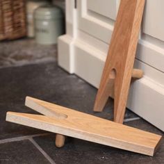 a wooden object sitting on the ground next to a door