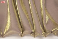 the curtain is shiny and has gold foil on it's edges, as well as some other metallic material