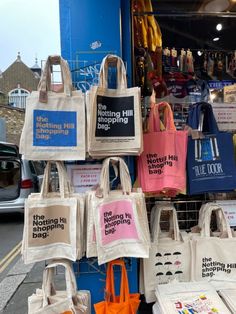 many bags are on display in front of a store with the words selling hill shopping