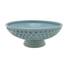 a blue bowl sitting on top of a white tablecloth with dots in the center