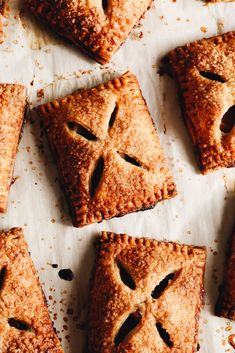 several pieces of pie are arranged on a sheet of paper with holes in the middle