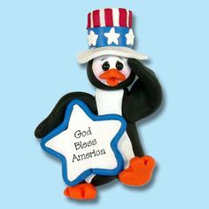 a penguin wearing a hat and holding a star in its paws with god bless america written on it