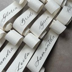 several rolls of toilet paper with the names of bride and groom written on them in cursive writing