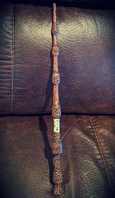 a wooden stick sitting on top of a leather couch