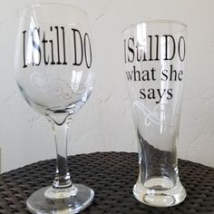 two wine glasses that say i still do what she says on the bottom one is clear