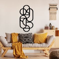 a living room filled with furniture and a large metal art piece hanging on the wall