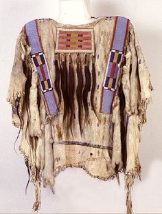 an old native american clothing hanging on a wall