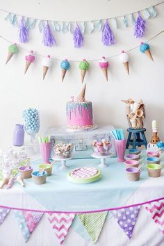 a table topped with cake and cupcakes covered in frosting