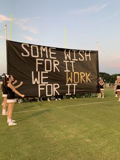 some cheerleaders are standing in front of a sign that reads, some wish for the work for it