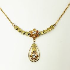 Vintage 14 Karat Yellow/Rose Gold And Diamond Floral Necklace- This Lovely Floral Necklace Features Two Round Brilliant Cut Diamonds* Set In Beautifully Detailed 14k Yellow And Rose Gold. *Chip Noted To Diamond In Drop Not Visible To Naked Eye. Approximate Total Diamond Weight: .14 Ct. Diamond Clarity: Vs2 Diamond Color: G Size: 16.5 Inches Drop: 25 Mm Weight: 1.1 Dwt. / 1.8 Gr. Stamped: 14k Very Good Condition, Professionally Polished. Will Come Packaged In A Gift Box Or Pouch (When Possible) A Vs2 Diamond, Floral Necklace, Diamond Color, Yellow Roses, Round Brilliant Cut Diamond, Yellow Rose, Diamond Clarity, Estate Jewelry, Round Brilliant