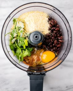 ingredients in a food processor ready to be blended into meat and vegetables for a meal