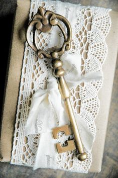 an old key is laying on a lace doily