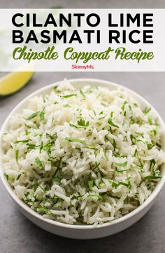 a white bowl filled with rice and garnished with scallions on the side