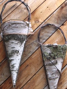 two white birch trees are hanging from the side of a wooden wall with barbed wire