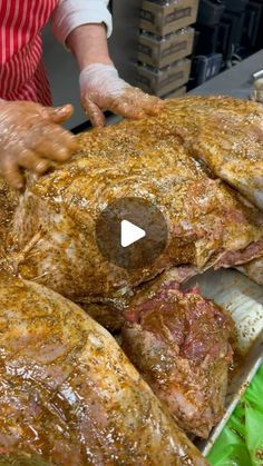 a person in an apron is cutting up some meat