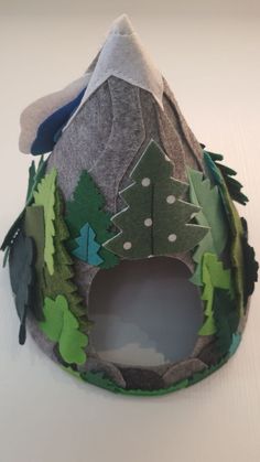 This mountain cave is made of felt. represents the shape of a cone without a bottom, the entrance to the cave is convenient for small toys, around the perimeter is decorated with various trees imitating the forest. such a mountain is very good for developing games with a child, for decor in a children's room. This felt mountain cave ready to ship Mountain Diy, Felt Mountain, Mountain Cave, Diy Mountain, Handmade Kids Toys, Play Mats