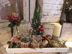 a white tray filled with christmas decorations and candles