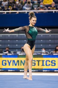 a woman in a green and black leotard