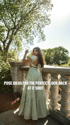 a woman in a dress standing on a balcony with the words pose ideas for the perfect look back at it shot