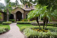 a house with landscaping and trees in the front yard