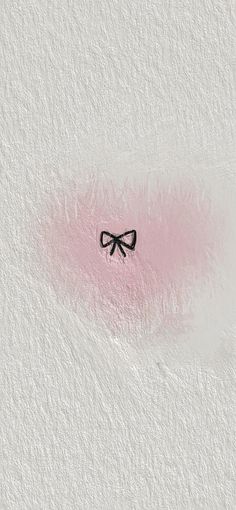 a pink and white wall with a black bow on it