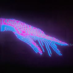 an image of a hand that is lit up in the dark with colorful lights on it