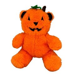 an orange teddy bear with a jack - o'- lantern on its head and eyes