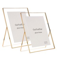 two gold metal frames with white paper on them