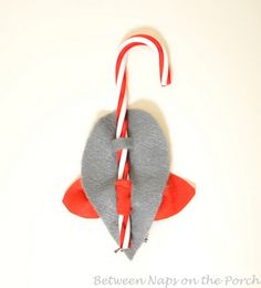 an ornament with candy canes in the shape of a heart on a white background