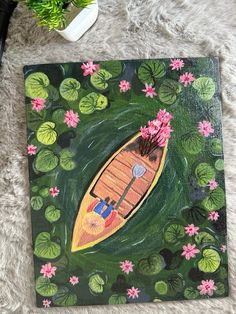 a painting of a boat floating on top of water lilies