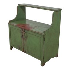 an old green wooden cabinet with red paint on the top and bottom part, against a white background