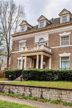 a large brick house with many windows on the top floor and two storyed building