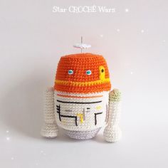 an orange and white crocheted toy with a hat on it