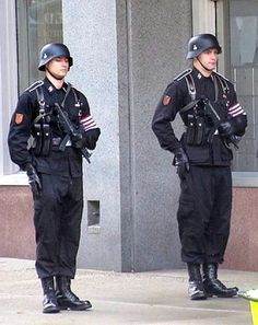 two police officers standing in front of a building