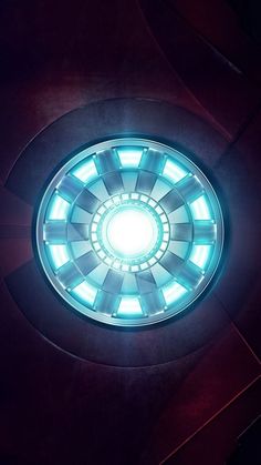 an iron man symbol is shown in the center of a circular object with light coming from it