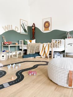 a child's bedroom with toy cars on the floor