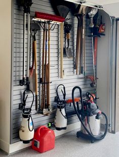 a garage filled with lots of different types of tools hanging on the wall next to each other