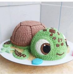 a cake made to look like a turtle and a turtle shell on a white plate