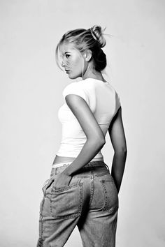 black and white photograph of a woman with her back to the camera, wearing jeans