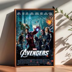 the avengers movie poster is hanging on a wall next to a plant and potted plant