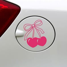 a sticker with two cherries attached to the side of a car