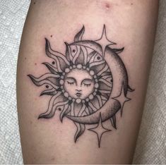 a sun and moon tattoo on the thigh, with eyes closed in front of it