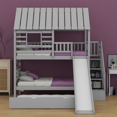 a bunk bed with a slide next to it in a room that has purple walls