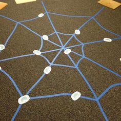 the floor is covered with blue tape and white circles that are connected to each other