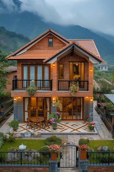 a large house with lots of windows and balconies on the second floor is surrounded by greenery