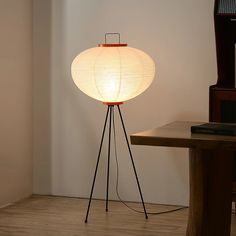 a floor lamp sitting on top of a wooden table