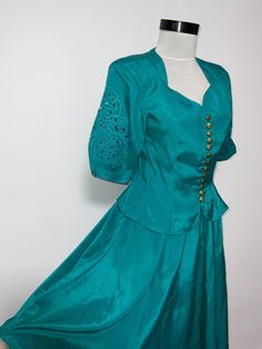 This is a beautiful suit blue green turqoise colour with embroidery  detalis on the puffy sleves  . The skirt has elasticated waist  , and the top is in the 80's/90's style.   Size label indicates D34-I/E 38or F36 Skirt - elastic waist  Minimum 60 cm  maximum 88cm Total length 73 cm Top  Closure with golden decorative Buttons Distance between shoulders 39 cm Length 53 cm lowest part Bust 86 cm Sleeve length 29/30 cm Perfect condition, like new Elegant Green Short Sleeve Sets, Blue Fitted Vintage Set, Fitted Vintage Blue Set, Fitted Costume Sets For Summer, Retro Fitted Blue Sets, Retro Blue Fitted Sets, Green Skirt Suit For Spring Party, Turquoise Fitted Wedding Sets, Vintage Formal Summer Sets