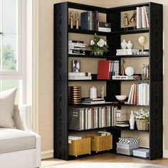 a living room filled with lots of furniture and bookshelves next to a window